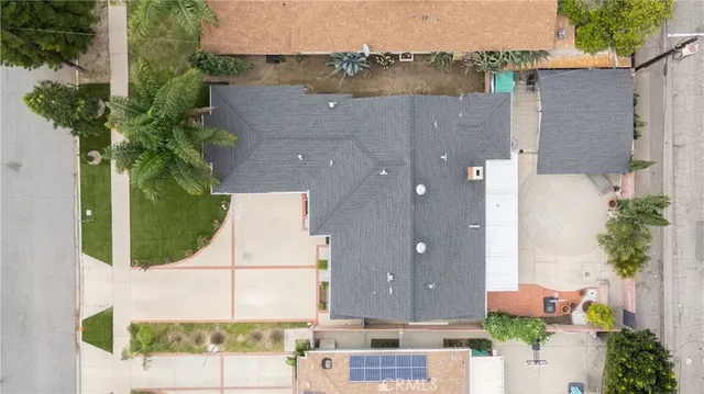 an aerial view of a house with a yard and lake view
