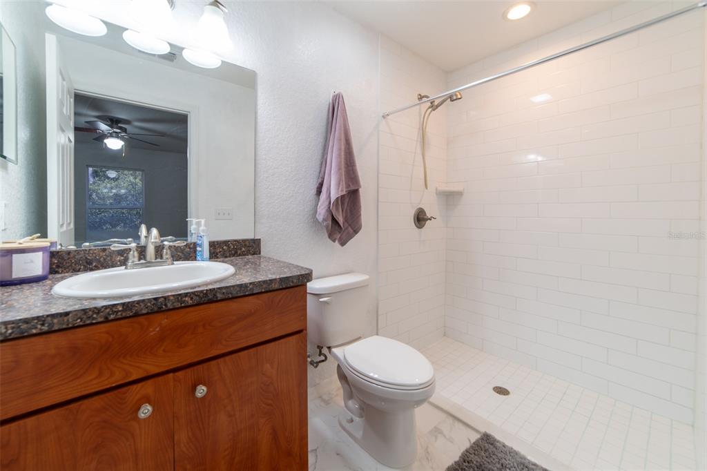 5107 Southwest 165th St Road Ocala, FL 34473 - Photo 20 of 34 a bathroom with a granite countertop sink toilet and shower