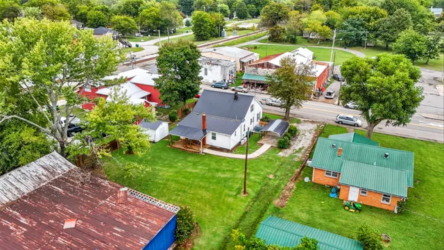 an aerial view of house with yard swimming pool and outdoor seating