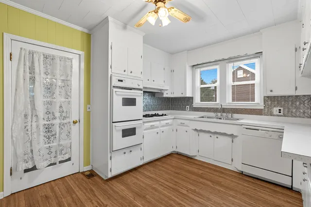 a view of a kitchen with wooden floor