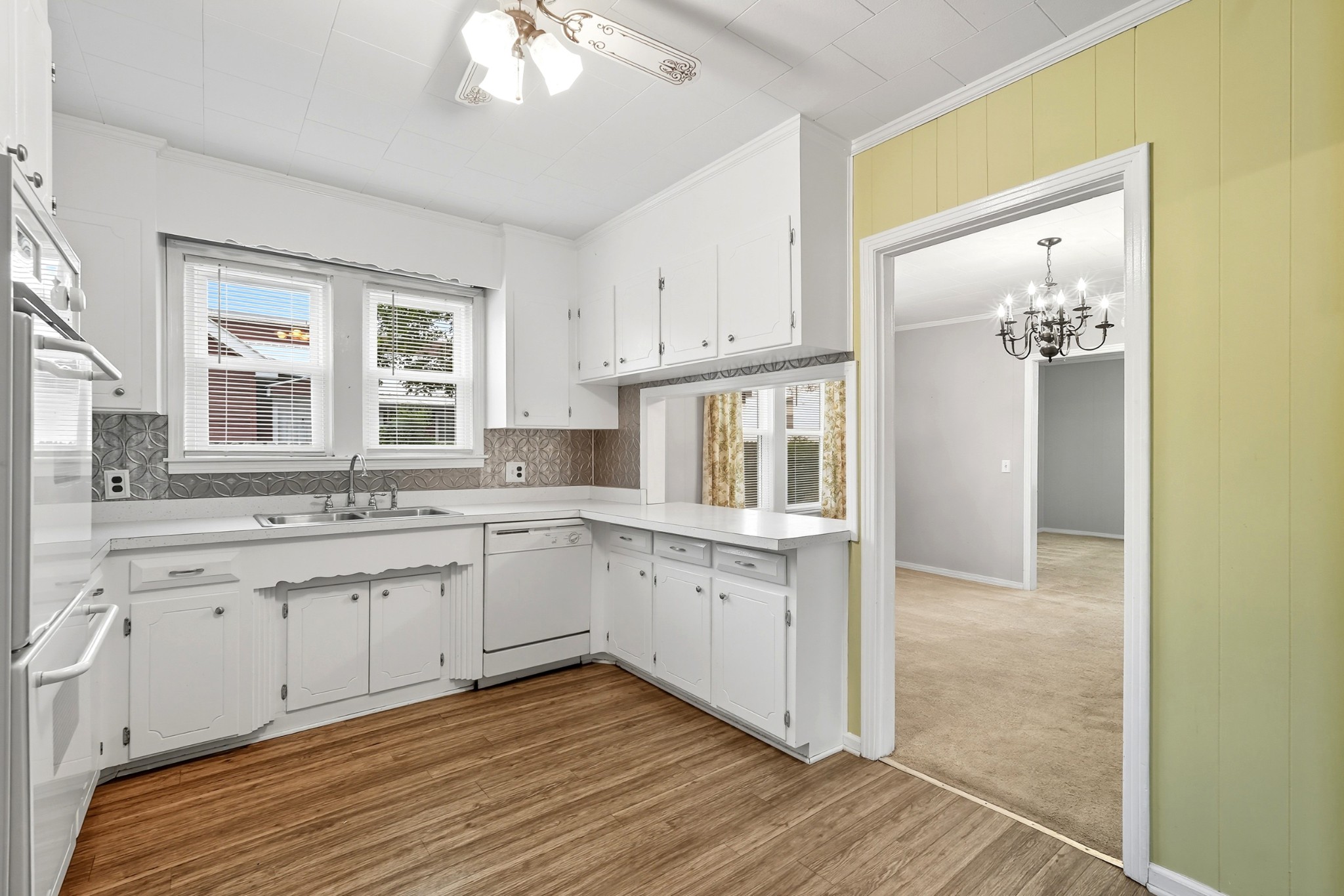 135 Main Street McEwen, TN 37101 - Photo 25 of 62 a kitchen with granite countertop white cabinets and white appliances