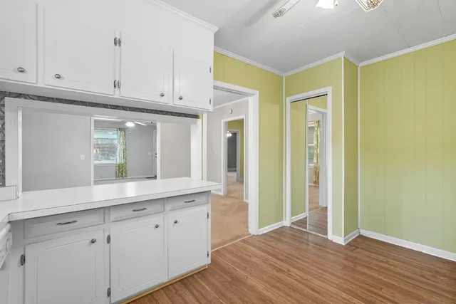 an empty room with windows and closet