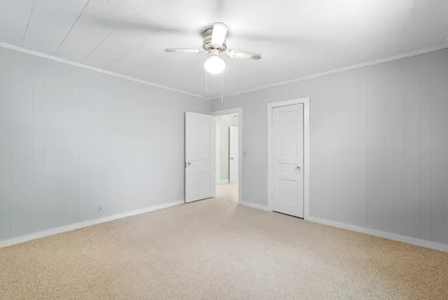 a view of a livingroom with a chandelier fan
