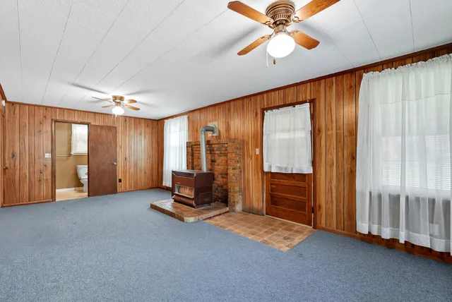 a bedroom with furniture and large window