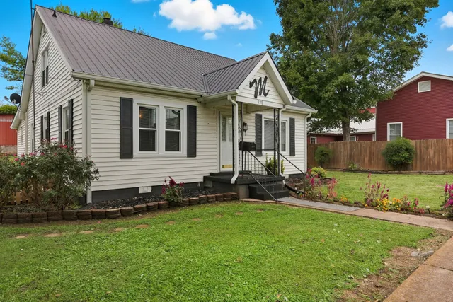 a front view of a house with a yard