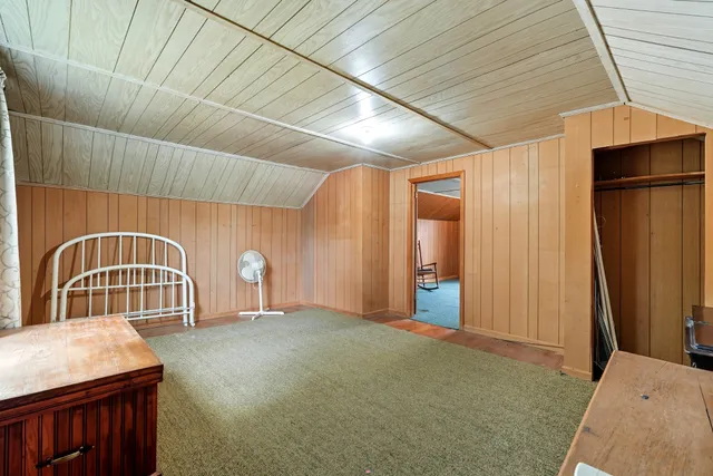 a view of a backyard with a garden and entertaining space