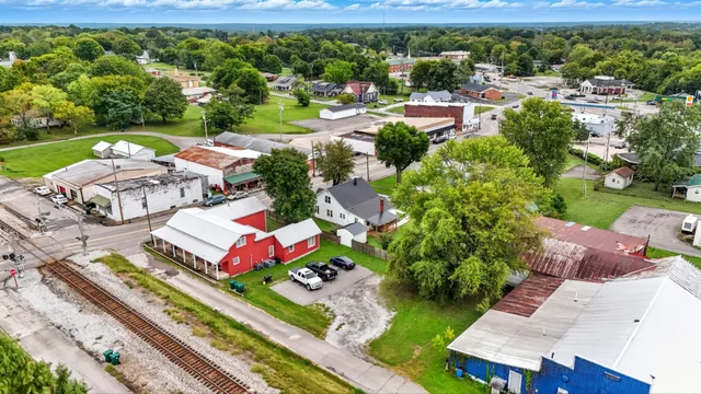 an aerial view of a house with yard swimming pool and outdoor seating