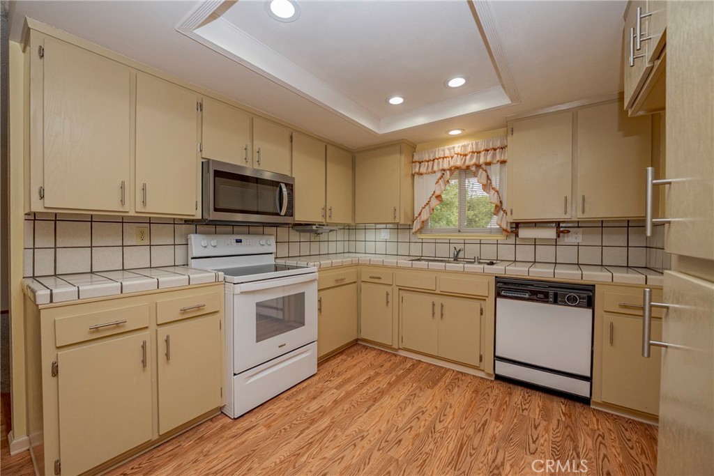 3449 Bautista Court Merced, CA 95348 - Photo 21 of 41 a kitchen with granite countertop white cabinets and white appliances