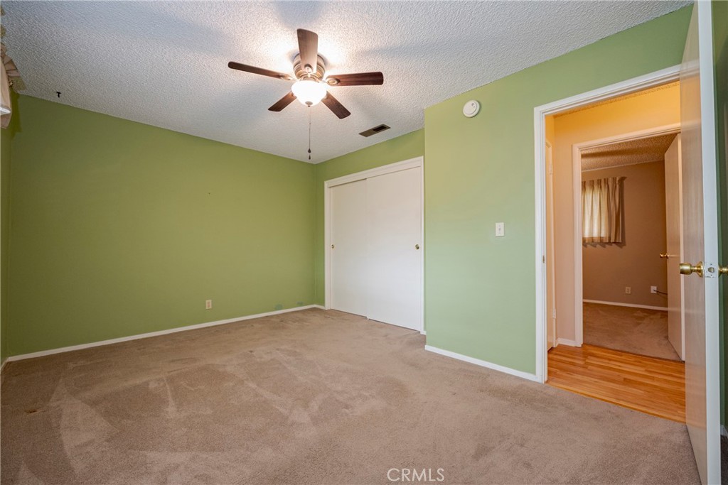 3449 Bautista Court Merced, CA 95348 - Photo 35 of 41 an empty room with closet and a chandelier fan