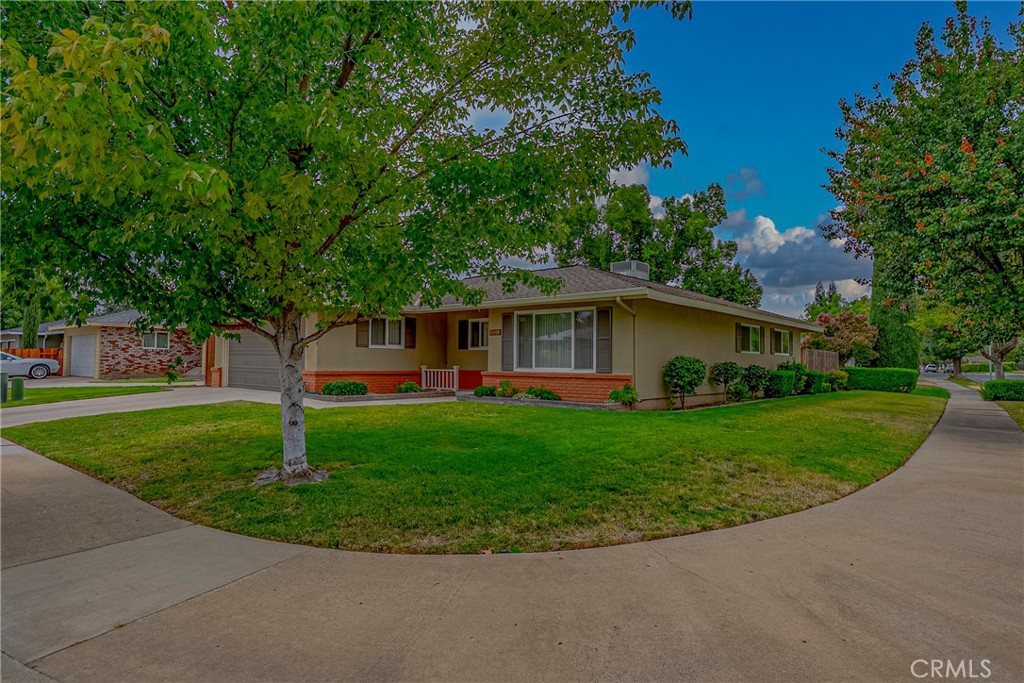 3449 Bautista Court Merced, CA 95348 - Photo 5 of 41 a front view of a house with a garden and trees