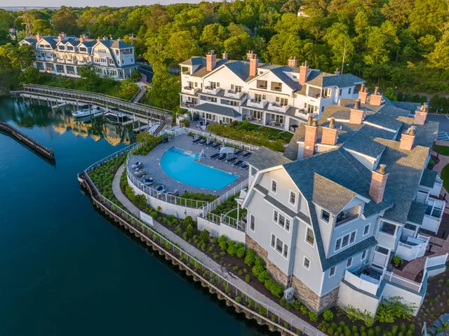 an aerial view of a house with a garden and lake view