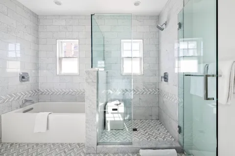 a bathroom with a granite countertop sink a toilet and shower