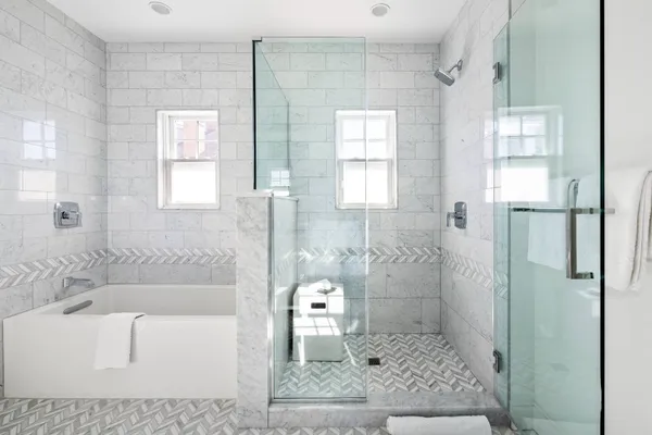 a bathroom with a granite countertop sink a toilet and shower