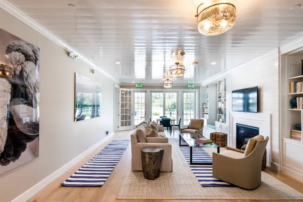 a living room with furniture a fireplace and a large window