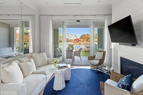 a living room with furniture a flat screen tv and a fireplace