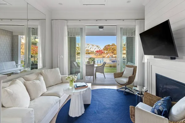 a living room with furniture a flat screen tv and a fireplace