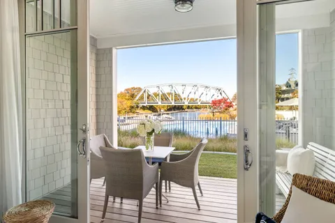 a view of a dining room with furniture a chandelier and wooden floor