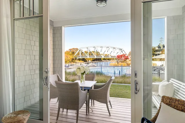 a view of a dining room with furniture a chandelier and wooden floor