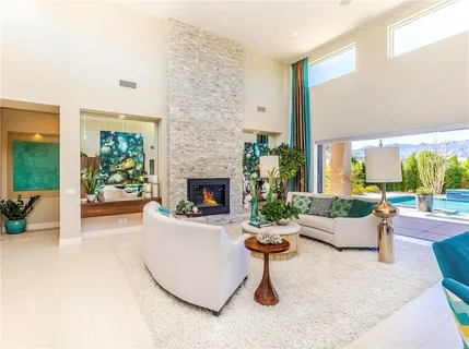 a dining room filled with furniture and chandelier