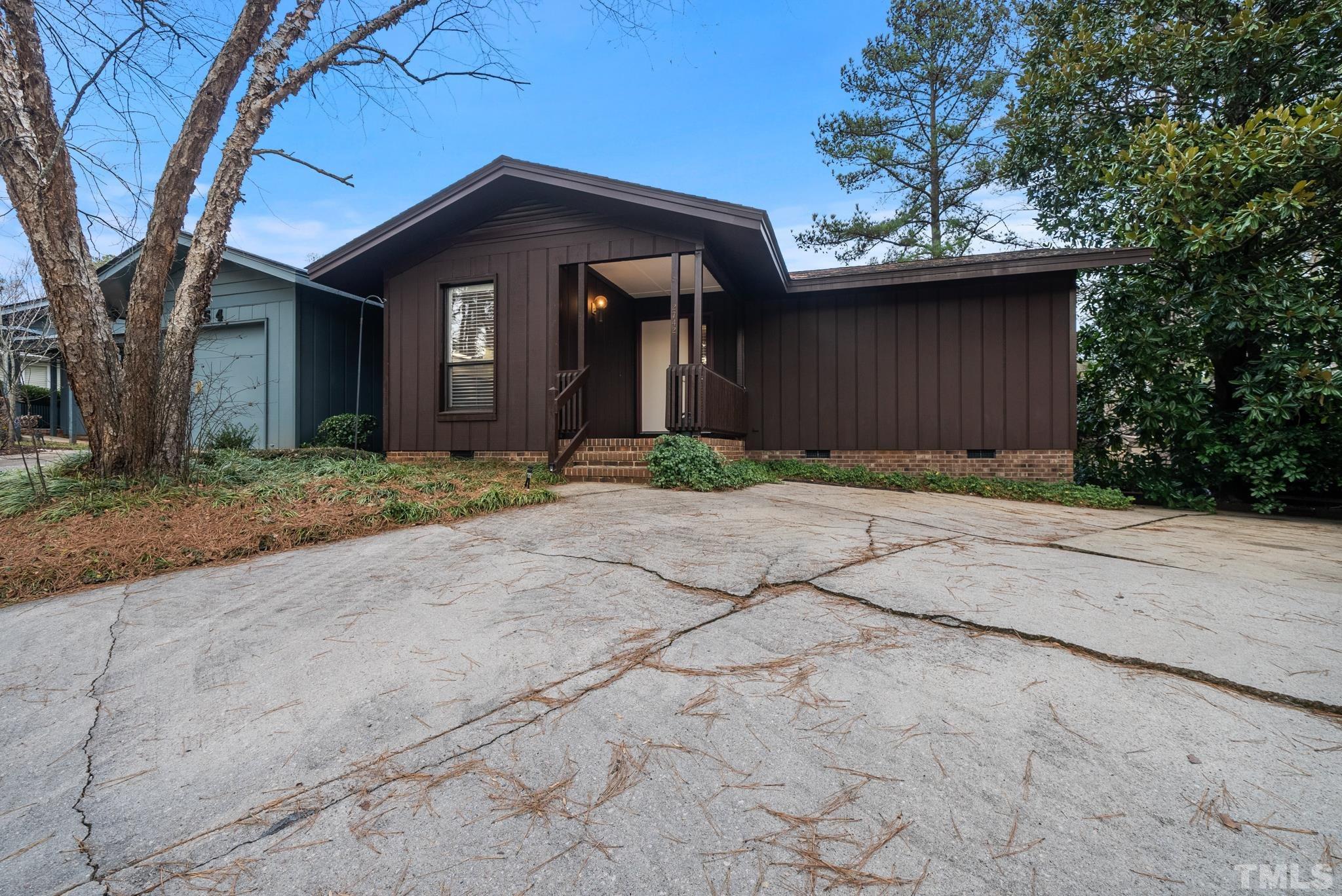 2742 Rue Sans Famille Raleigh, NC 27607 - Photo 2 of 21 a front view of a house with a yard and garage