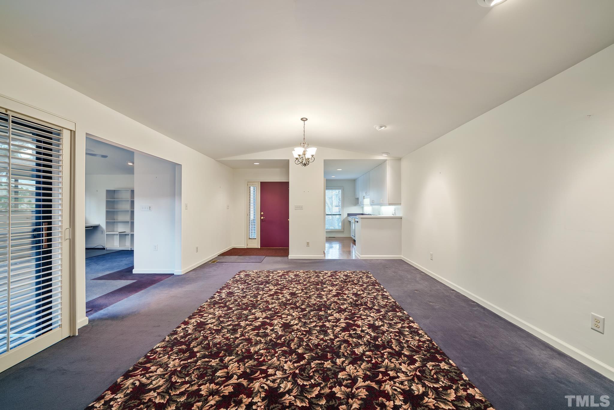 2742 Rue Sans Famille Raleigh, NC 27607 - Photo 5 of 21 a big room with chandelier fan and wooden floor