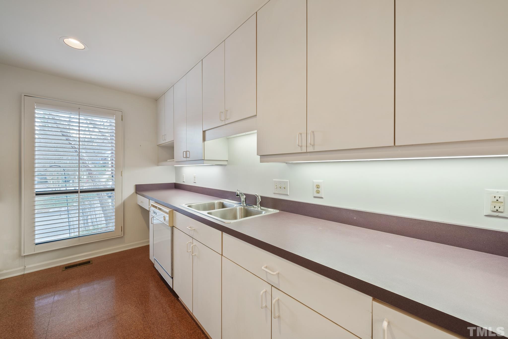 2742 Rue Sans Famille Raleigh, NC 27607 - Photo 6 of 21 a kitchen with granite countertop white cabinets and a stove