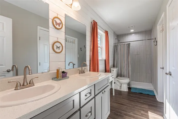 a bedroom with furniture and a flat screen tv