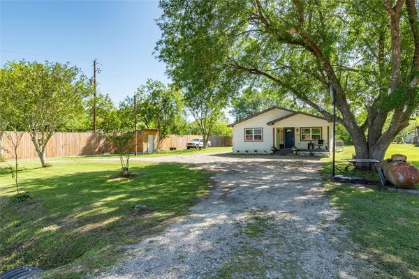 a view of a house with backyard and sitting area