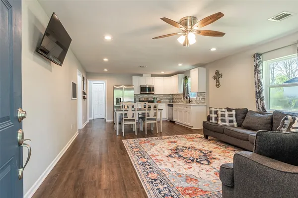 a living room with furniture and a rug