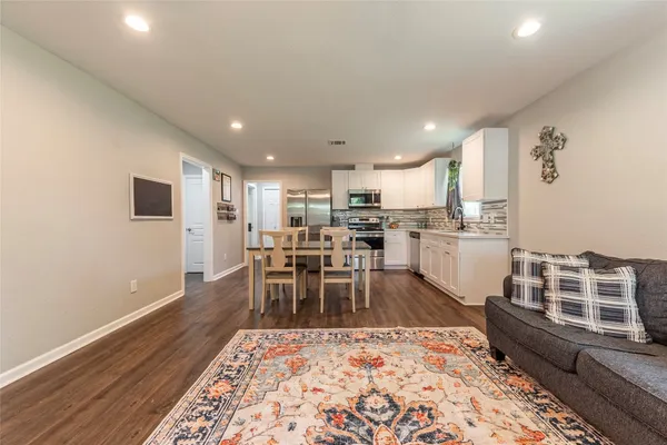 a kitchen with refrigerator cabinets and wooden floor