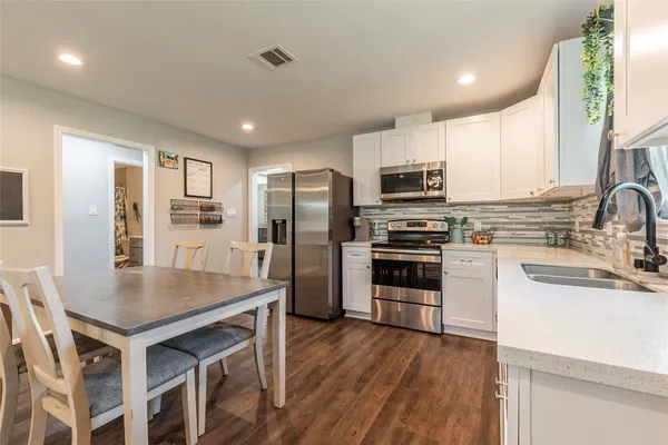 a kitchen with sink and large window
