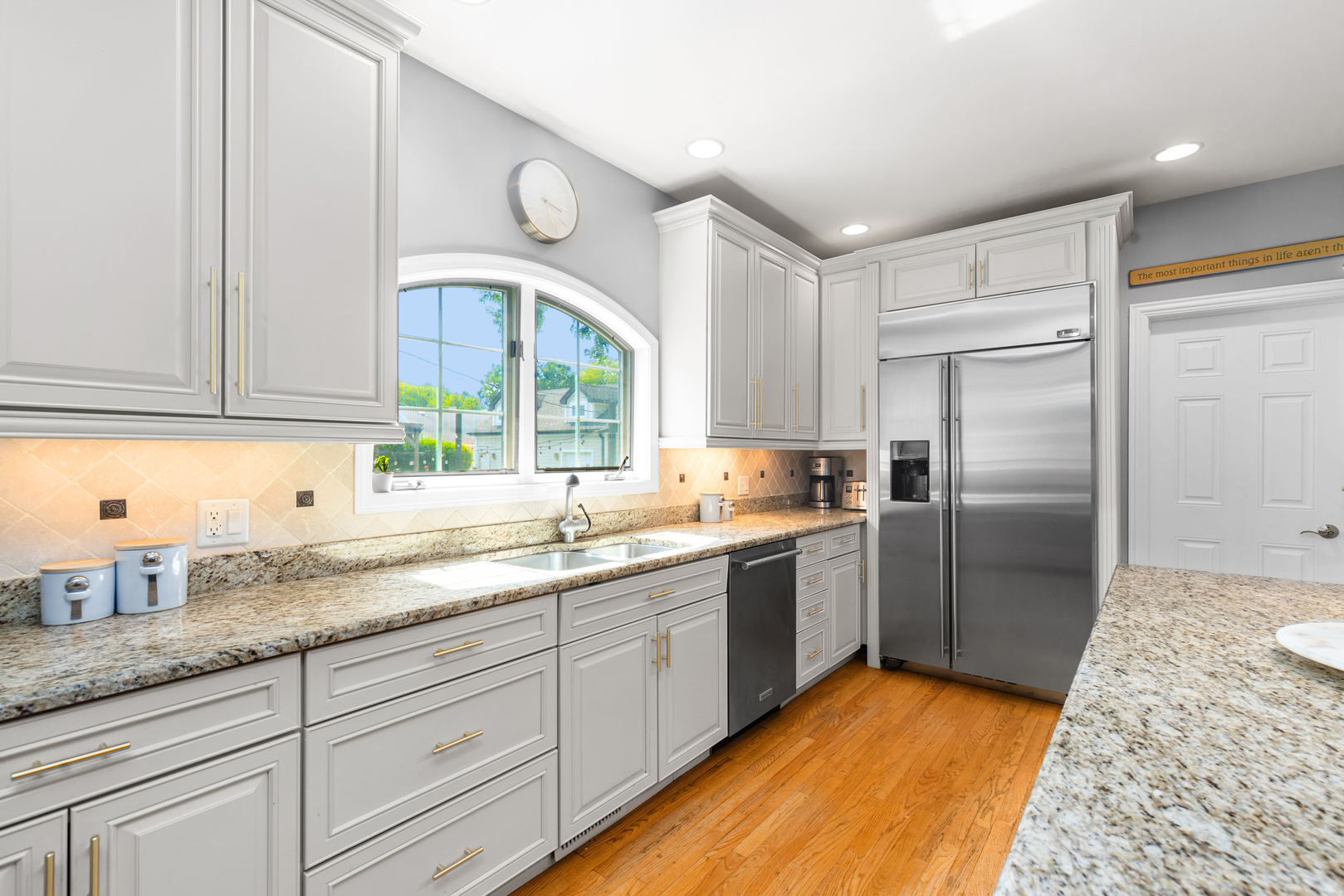 6972 West Imlay Street Chicago, IL 60631 - Photo 13 of 42 a kitchen with granite countertop a sink stainless steel appliances and cabinets