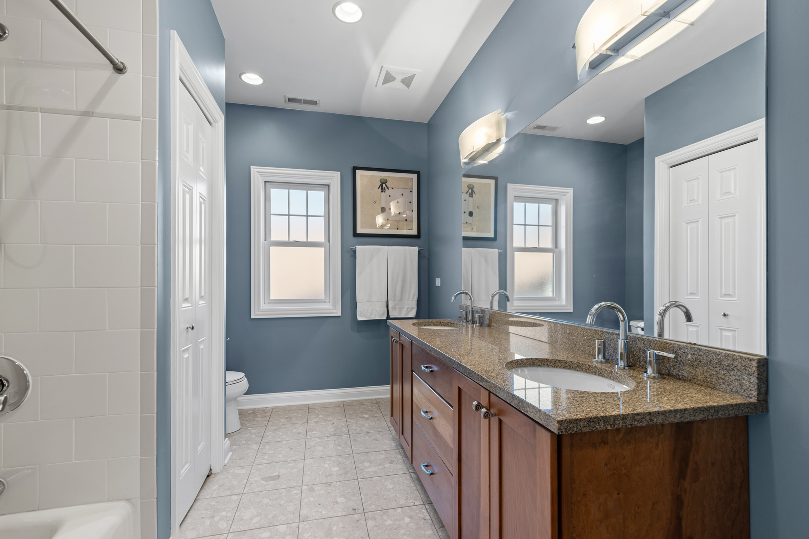 6972 West Imlay Street Chicago, IL 60631 - Photo 25 of 42 a bathroom with a granite countertop sink and a mirror