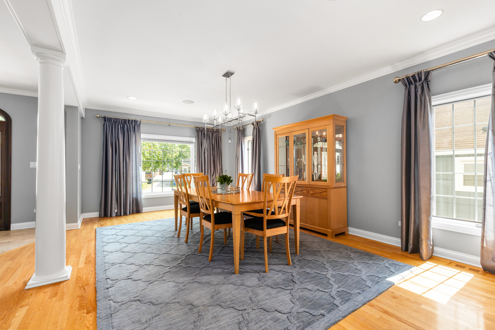 6972 West Imlay Street Chicago, IL 60631 - Photo 4 of 42 a dining room with furniture a rug and a chandelier