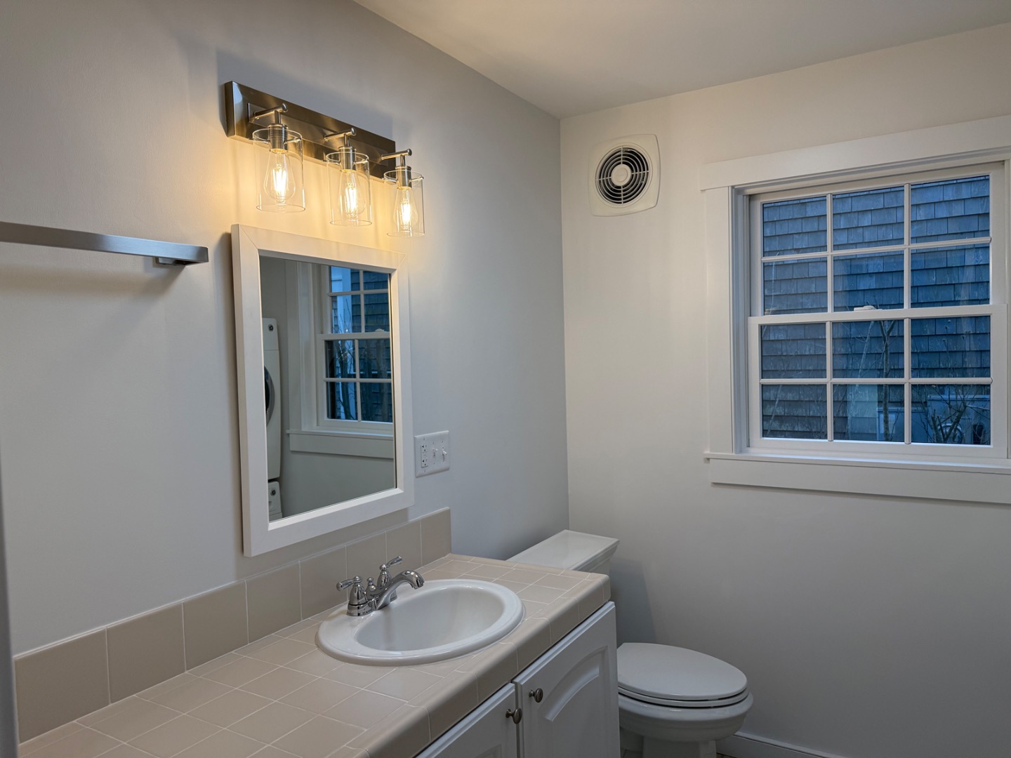 106 Old South Road, Unit A B Nantucket, MA 02554 - Photo 13 of 24 a bathroom with a sink a toilet and a mirror