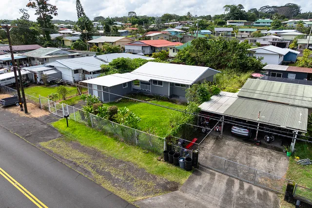 an aerial view of a house with garden space and street view