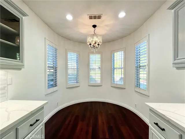 a kitchen that has a lot of windows and ceiling fan