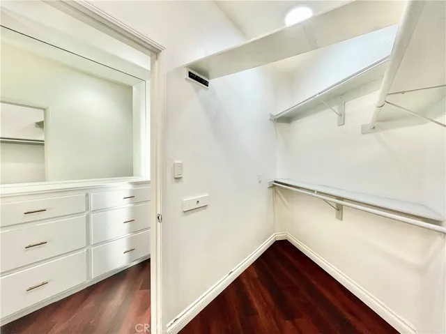 a view of walk in closet with empty racks