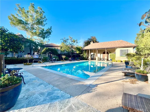 a view of a tables and chairs in back yard of the house
