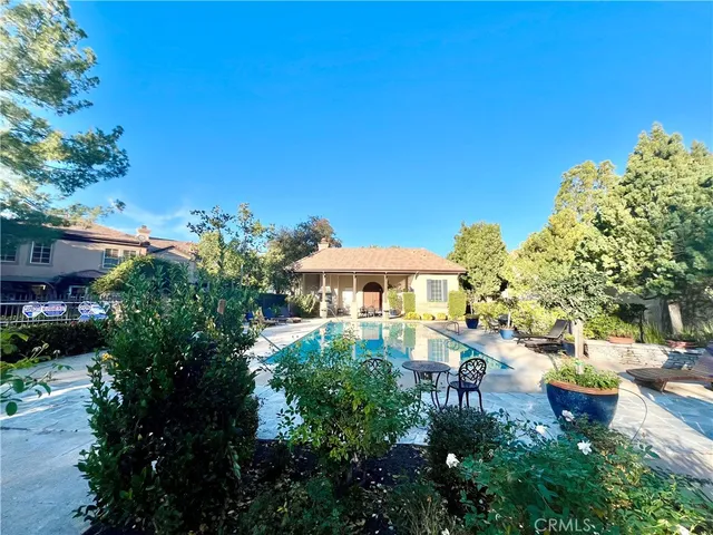 a swimming pool with outdoor seating yard and furniture
