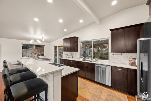 8678 Mount Majestic Road Sandy, UT 84093 - Photo 13 of 37 Vaulted ceilings, recessed lighting, and rich wood-finish cabinetry