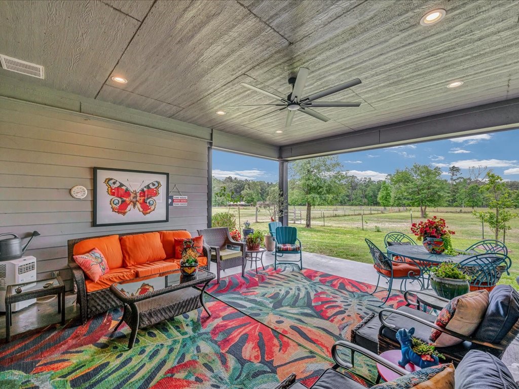 104 Wheeler Road Lufkin, TX 75901 - Photo 27 of 45 a living room with patio furniture and a floor to ceiling window