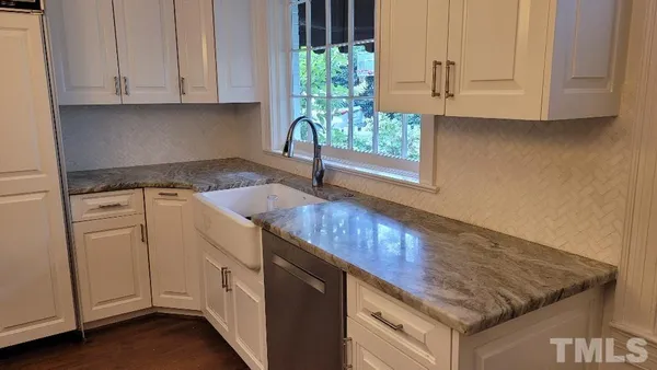 a bedroom with a bed a chandelier and a window