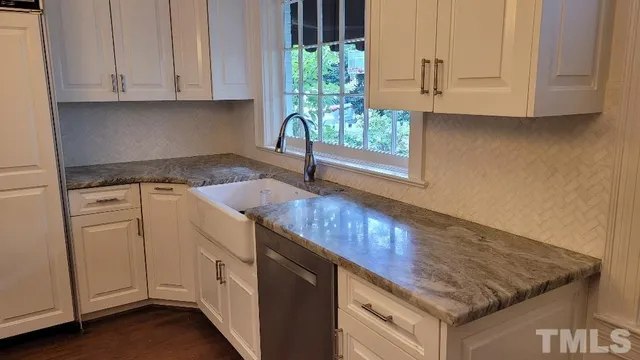 a bedroom with a bed a chandelier and a window