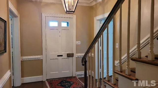 a view of an entryway with wooden floor and staircase