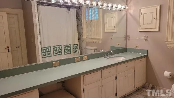 a view of a pathway of a house with wooden fence