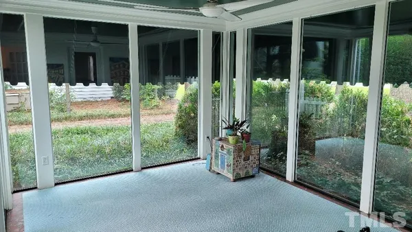 a view of a patio with table and chairs and potted plants