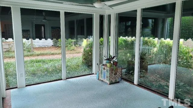 a view of a patio with table and chairs and potted plants