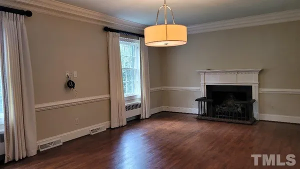 a view of a dining room with furniture and chandelier