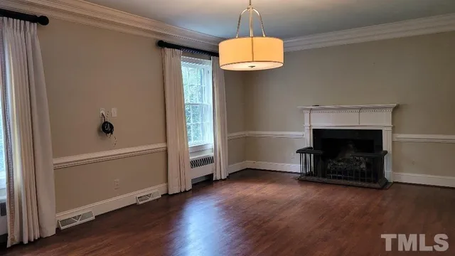 a view of a dining room with furniture and chandelier